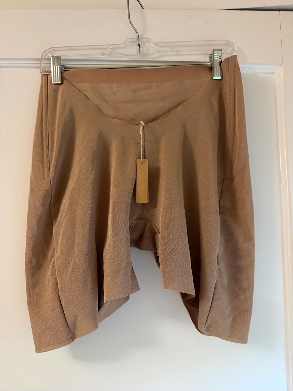 Skims low back under garments. Never worn